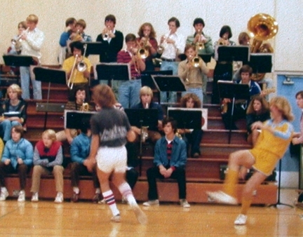 John Foster, Jill Pampeyan, and others in pep band at indoor soccer assembly.
